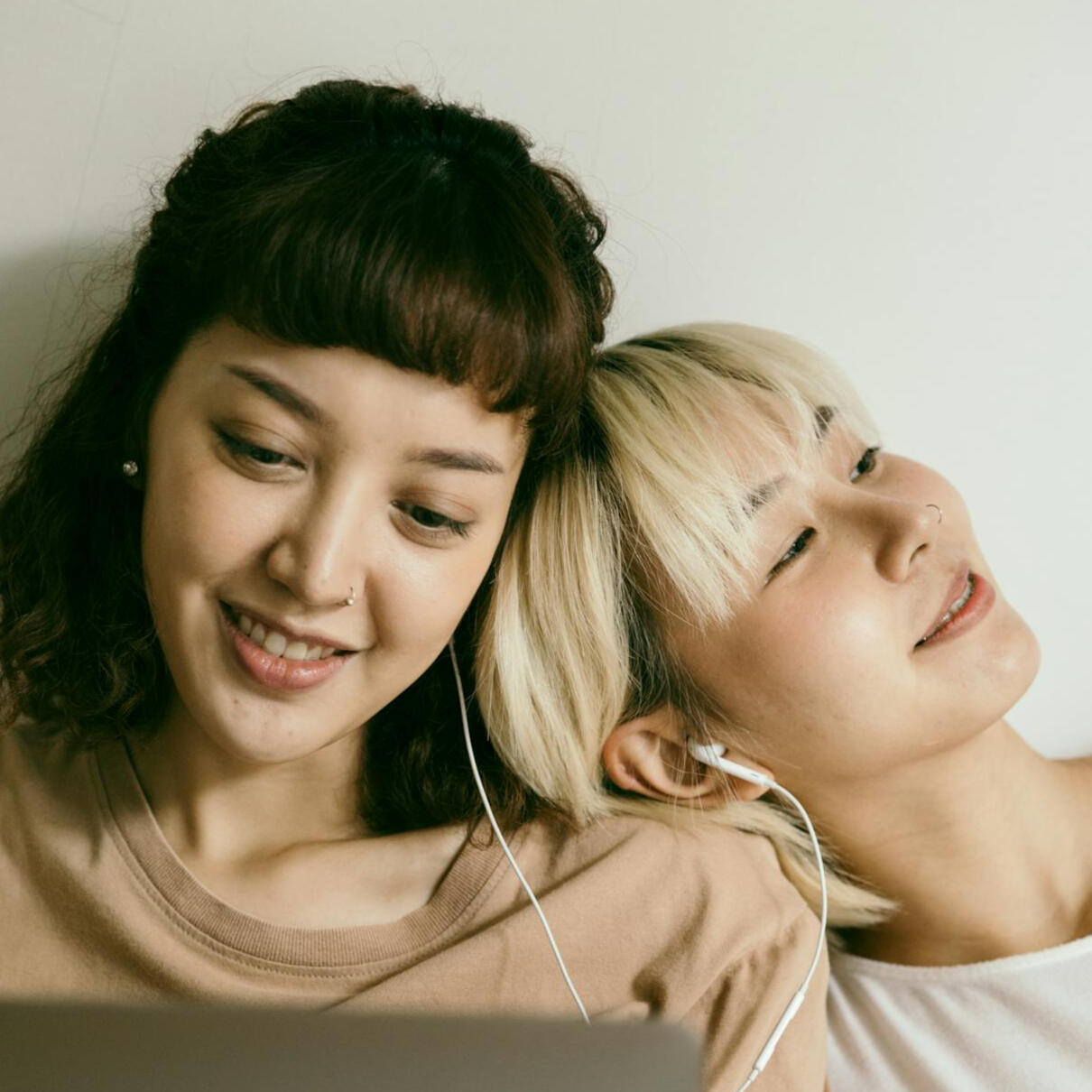 girl resting on her friends shoulder