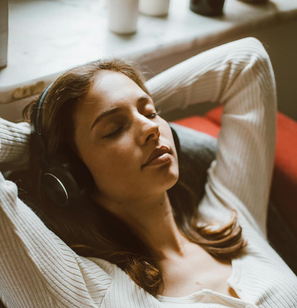 Young woman with eyes closed and headphones on