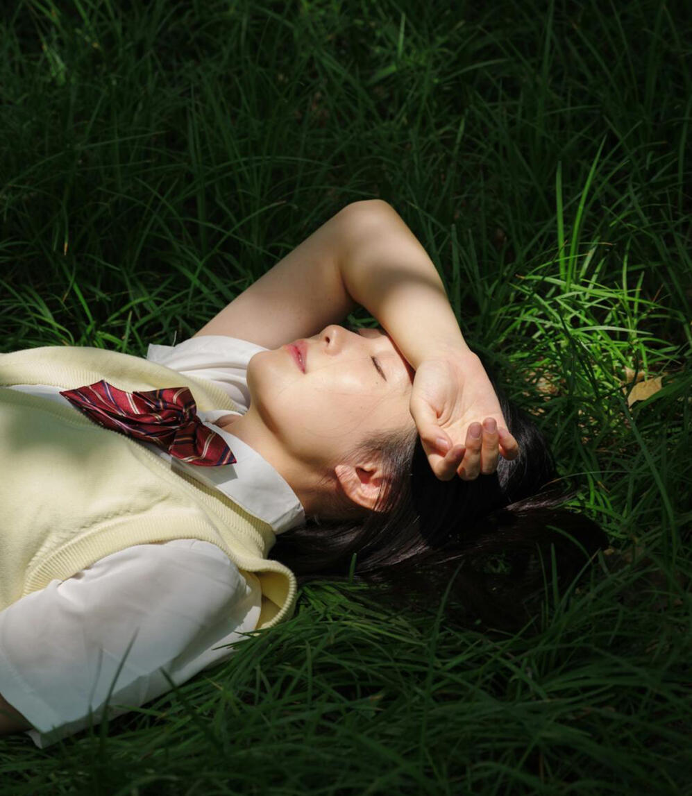 Young woman resting on grass