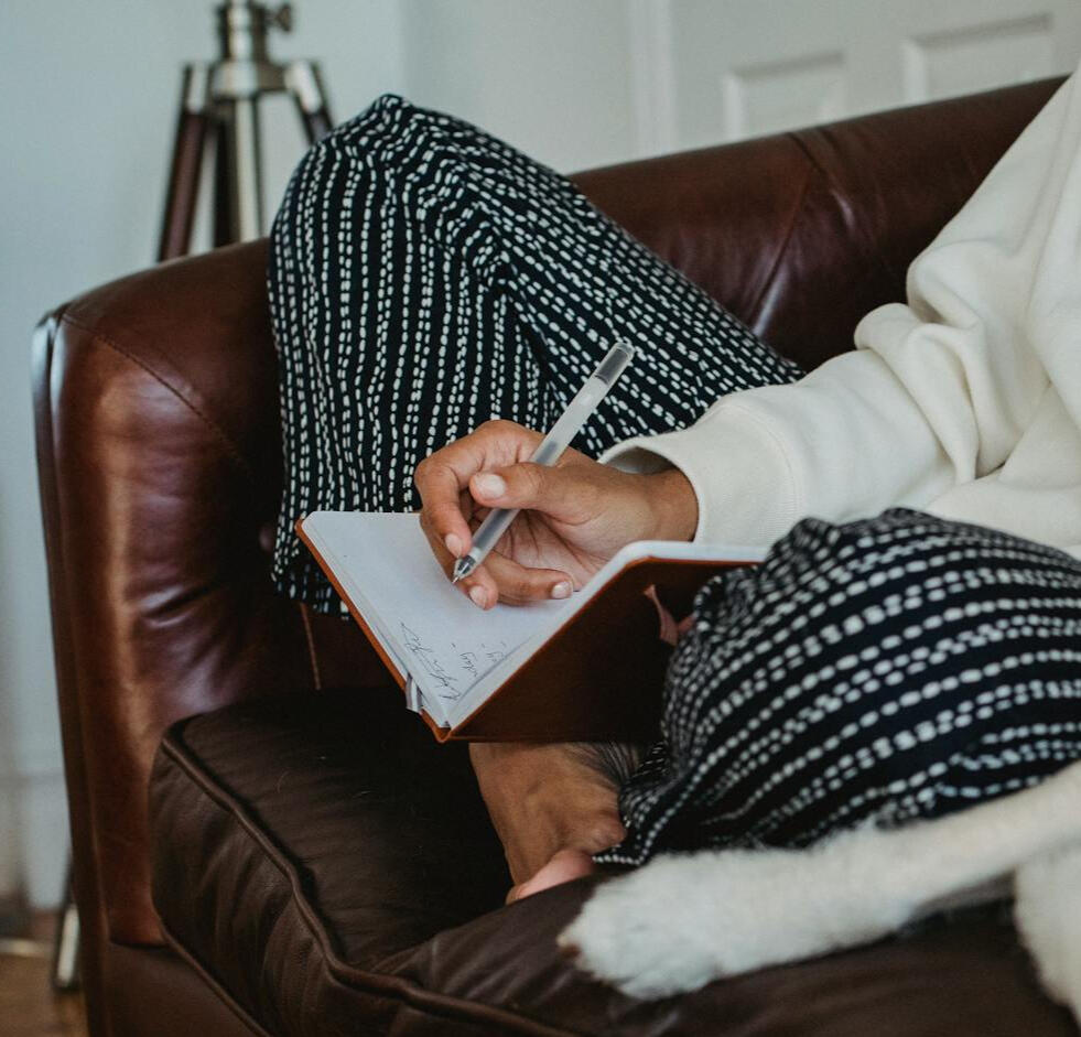 girl seated with a journal in her lap