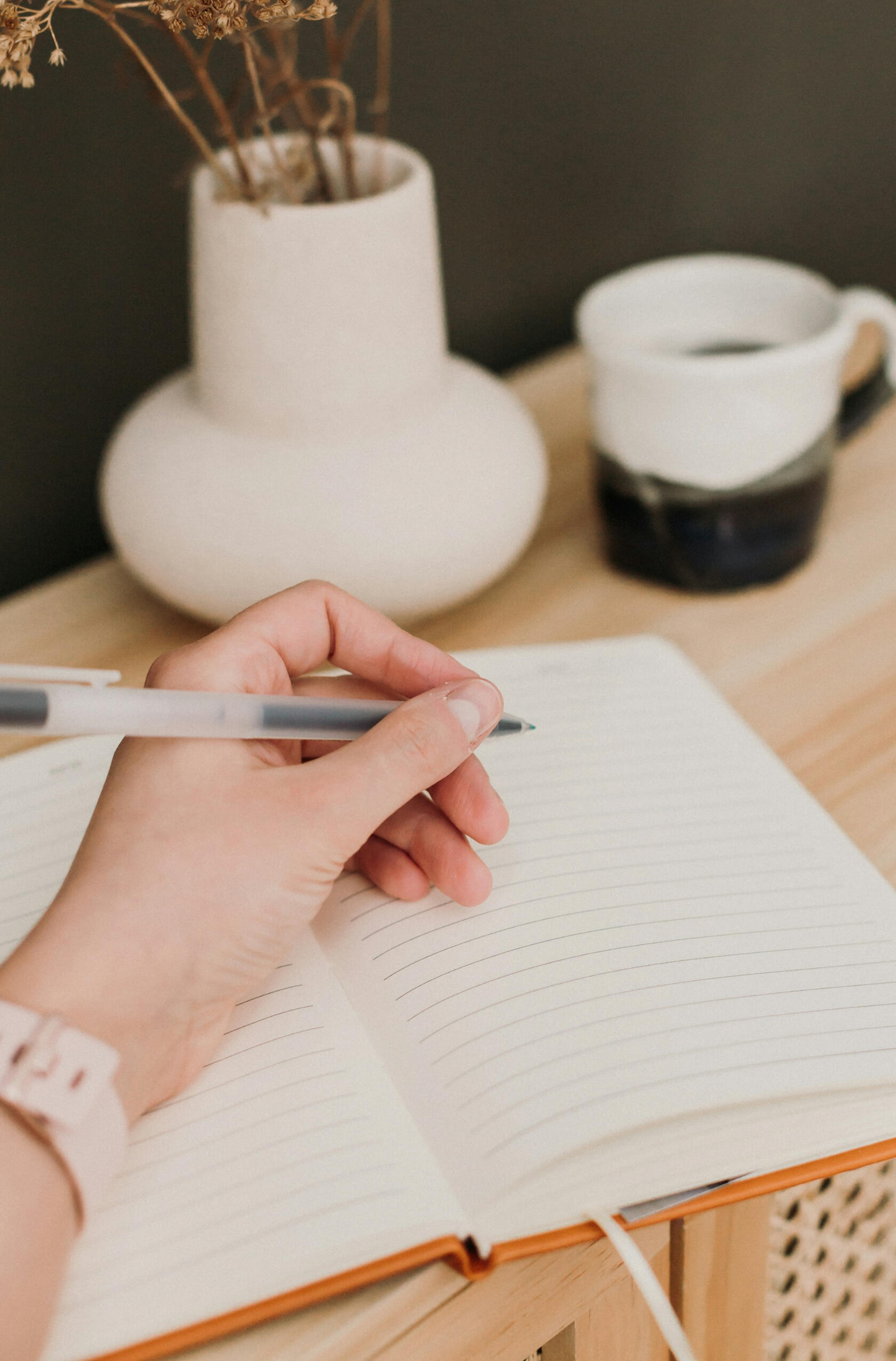 a hand poised to write in a journal