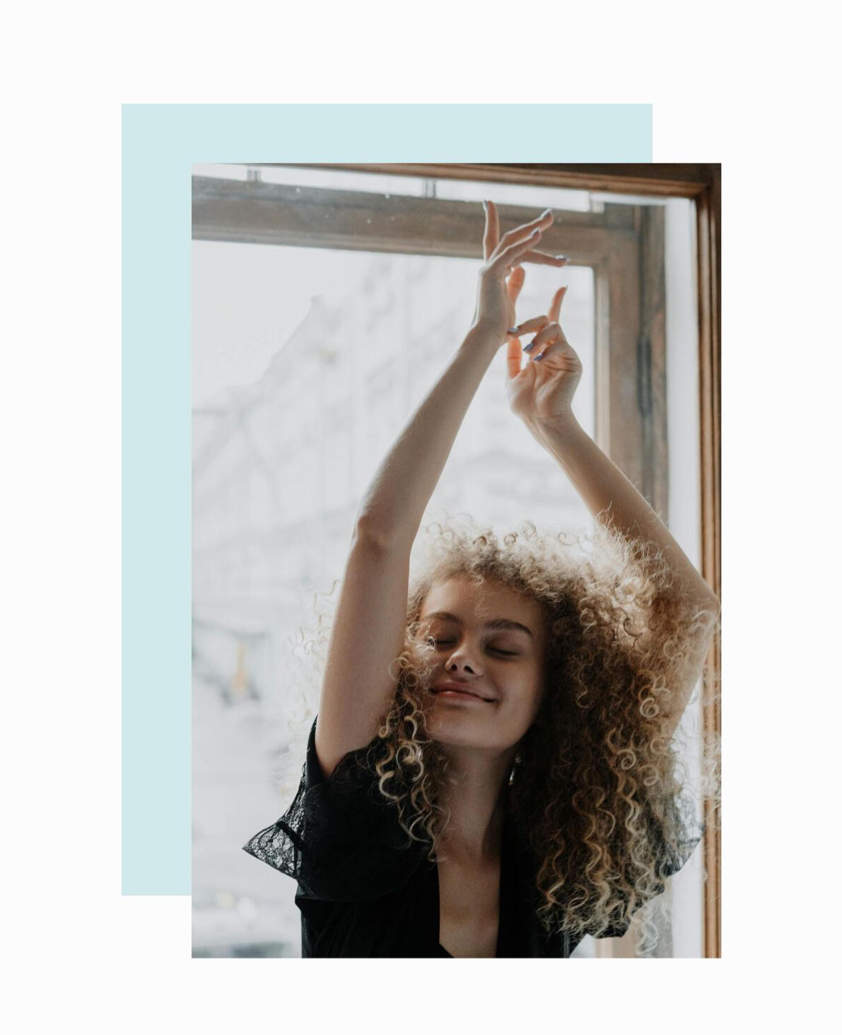 girl with her hands raised in a graceful pose